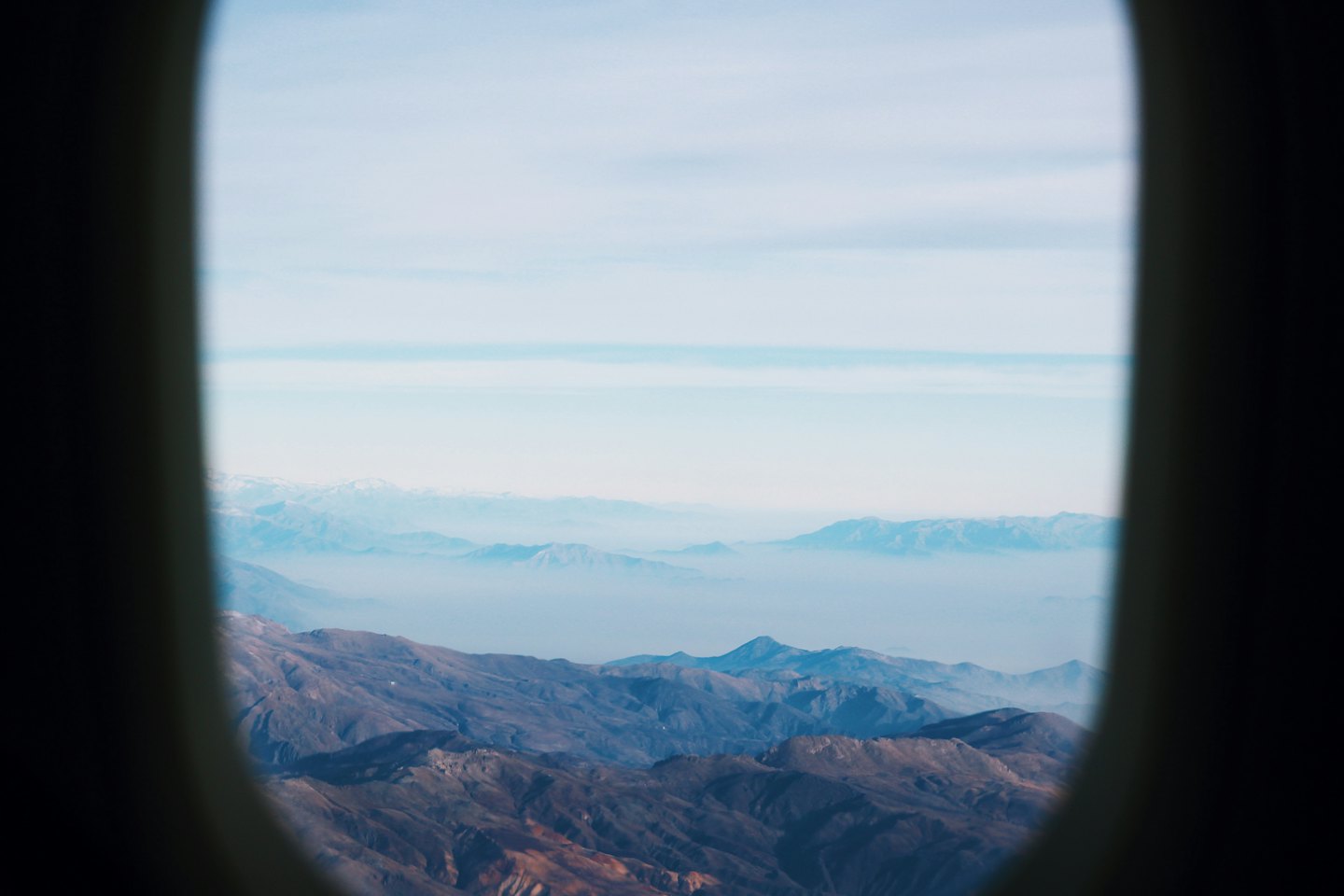 Mountain ranges visible through an airplane window.